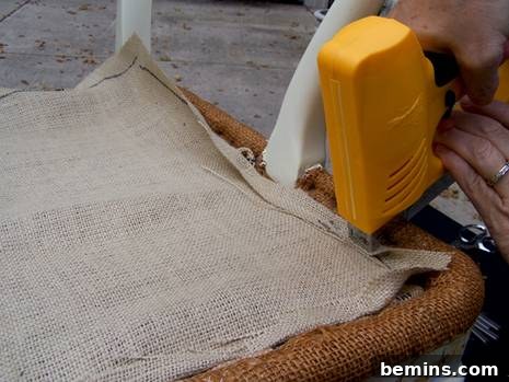 Securing the burlap to the chair frame