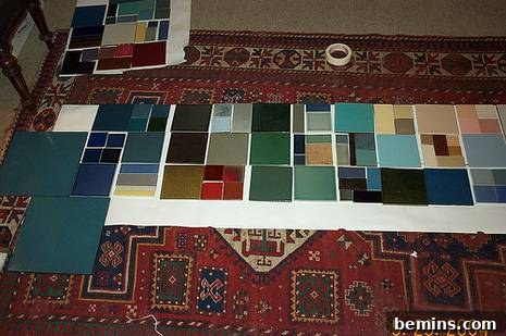 A mock-up of the kitchen counter design using square fabric patterns laid out on a throw rug.
