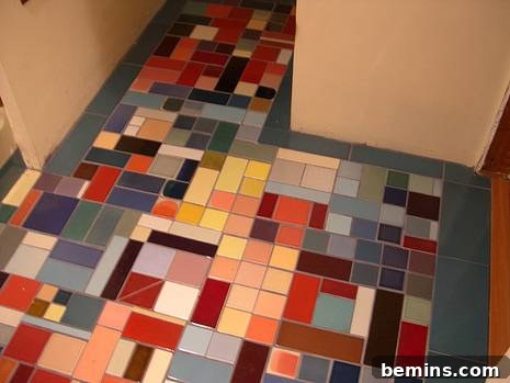 A finished tile floor in a bathroom, featuring many different colored tiles.