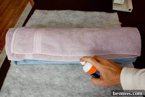 Turn Old Towels into a Cozy Body Pillow 5 Wrapping towels in dacron