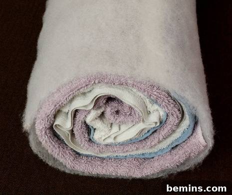 Turn Old Towels into a Cozy Body Pillow 6 Securing dacron with spray adhesive