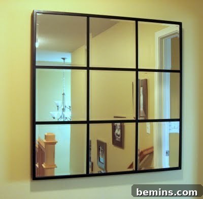 Craft Your Own Pottery Barn Grid Mirror 2 Nine-paneled mirror with thin wooden slats, reflecting a room, showcasing a DIY home decor project