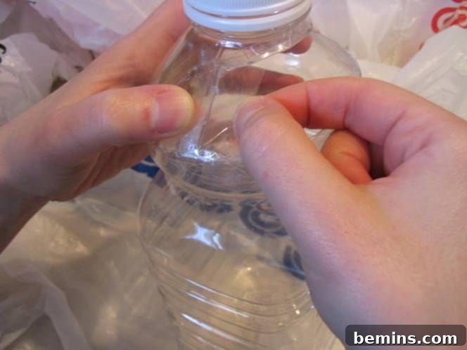 Applying tape to the edges of a plastic bottle to create a safe and durable opening