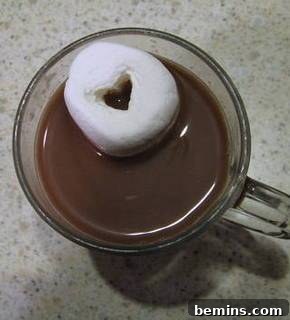 Hot cocoa with a heart-shaped marshmallow, a simple and heartwarming treat.