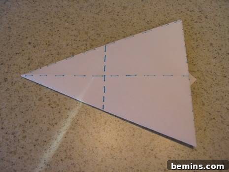 Origami Bunny: A Hopping Good Time 11 Lifting the tips up and folding them at the bottom to create the bunny's ears.