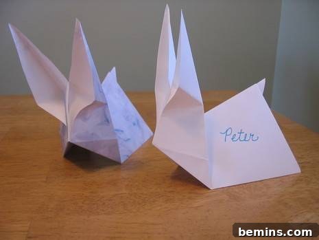 Two origami rabbits on a table
