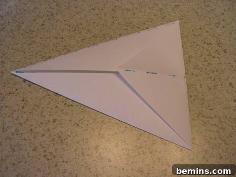 Origami Bunny: A Hopping Good Time 7 Folding the previous fold slightly past the edge to create the bunny's tail.