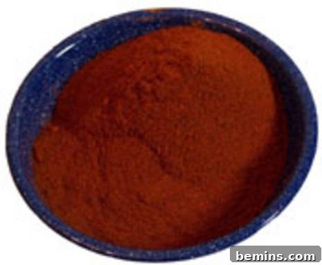 A blue bowl full of a ground up red substance.