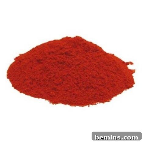 Use Spices Like a Pro: Volume II 5 A red mound of powder sits on a white surface.