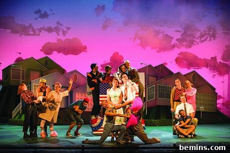 Colorful curtain printed with pink sky, green floor with people in front of the house.