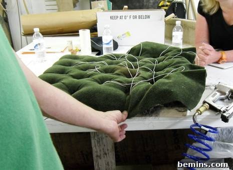 Finishing touches: attaching side fabric to precisely create natural, elegant folds around the tufted edges