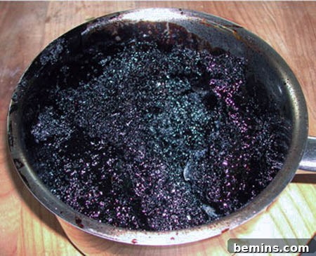 Burnt food stubbornly stuck to the bottom of a pan, a common kitchen mishap.