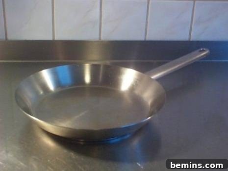 A clean silver pan, the result of effective burnt food removal.