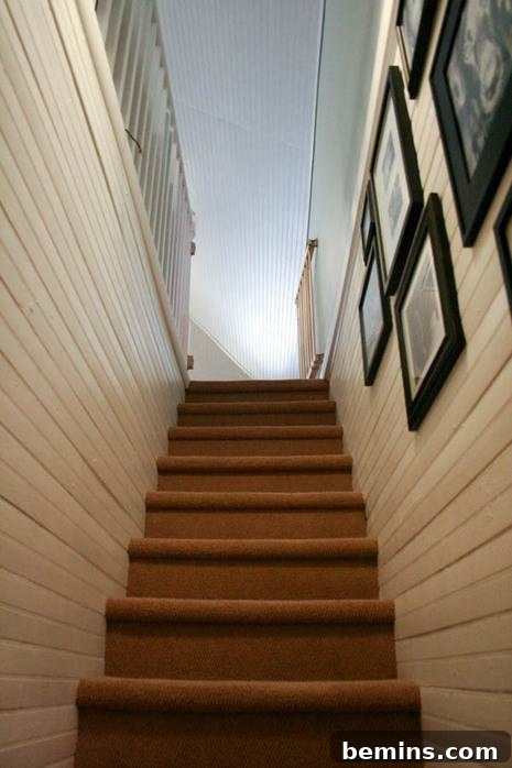 Wood Plank Walls Leading Upstairs to a Newly Renovated Attic Room