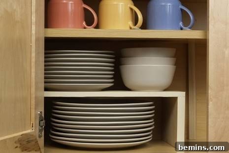 Kitchen cabinet with a custom-made helper shelf for plates and bowls