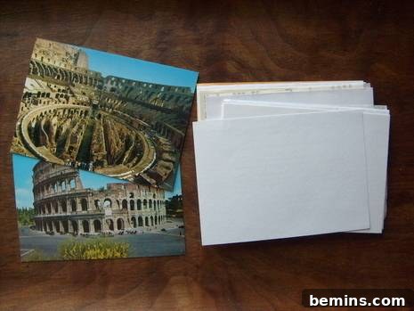Closeup of two identical postcards and a stack of various recycled paper cut to size