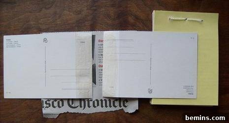 Applying a thin, even layer of white craft glue to the scored flap of a postcard cover