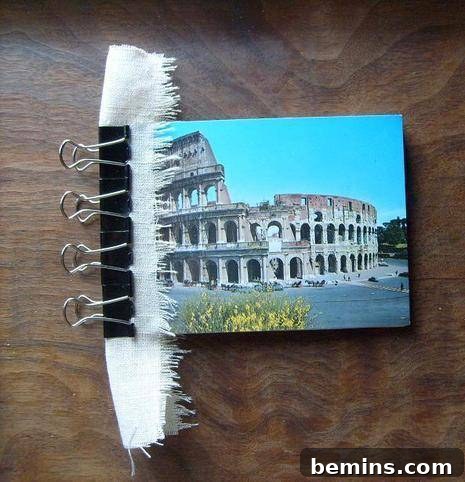 Applying a fabric strip to the spine of the notebook for an optional decorative and durable finish