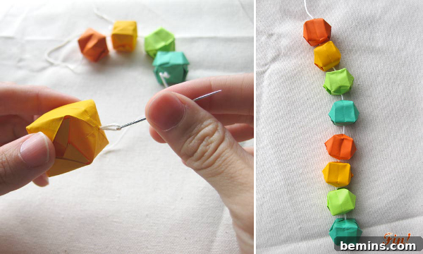 7 Fall Garlands to Craft for a Cozy Weekend 5 Intricate origami waterball garland in vibrant blue and green colors, creating a unique decorative string.
