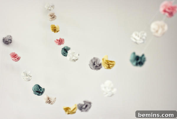 7 Fall Garlands to Craft for a Cozy Weekend 7 Delicate miniature fabric flower garland in soft, muted tones, perfect for a subtle and elegant decoration.