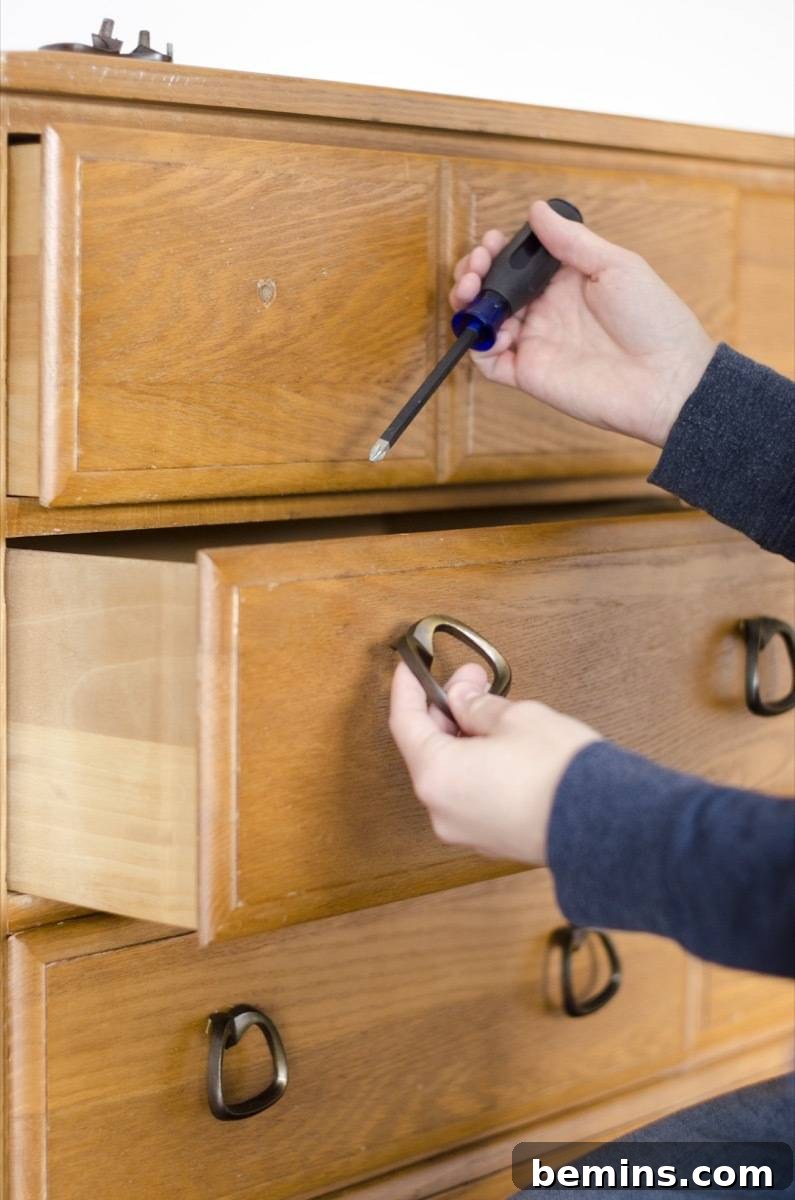Image showing the removal of hardware from the dresser. This is the first step in preparing the dresser for repainting.