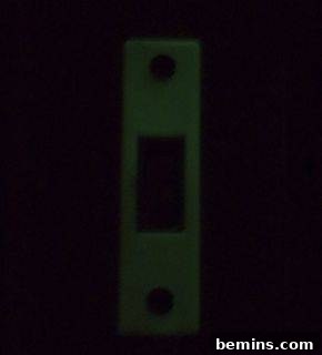 Glow in the dark light switch insert in a hallway with limited light