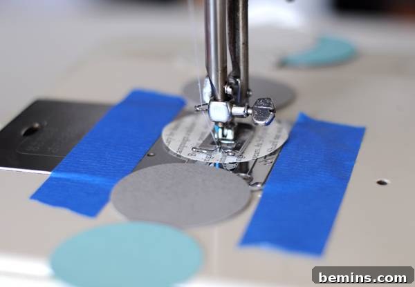 Budget-Friendly Modern Paper Holiday Garland 4 Sewing paper circles together to create a garland