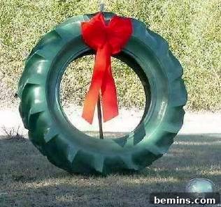 Ultimate DIY Holiday Wreath Ideas 14 A large automobile tire with a red bow placed at the top to make it look like a Christmas wreath.