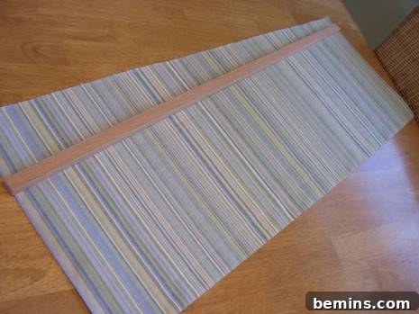 A Fresh Look: DIY Window Treatments for My Craft Room 4 A striped, long window treatment laying on a table. Demonstrating the versatility of fabric choices for DIY window coverings.