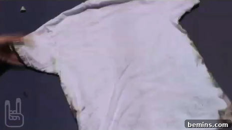 A white t-shirt spread on grey floor.
