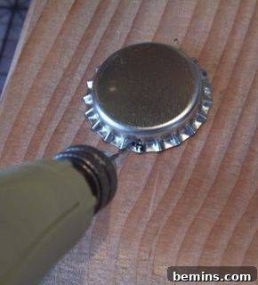 Bottle cap with a jump ring attached