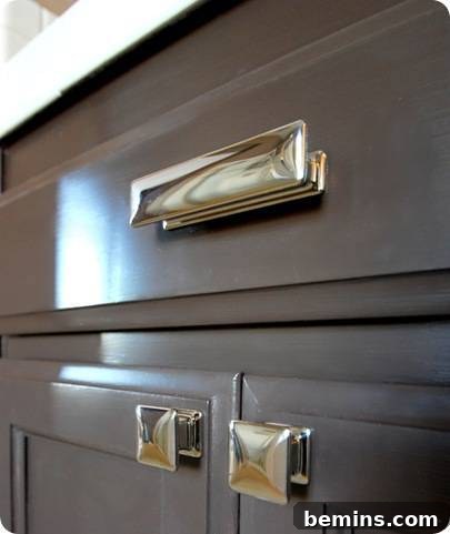 Elevate Your Builder's Oak Vanity 4 The chrome handles on a vanity cabinet.