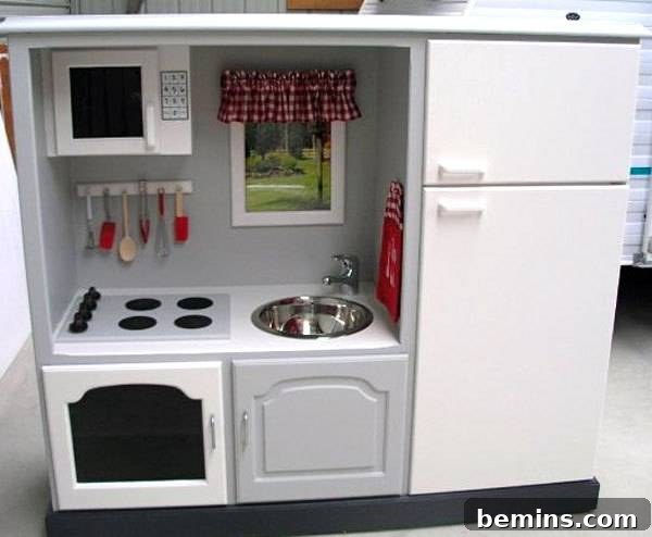 A kitchen area containing a refrigerator, stove, sink and a microwave.