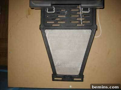 Black form with quadrangle bottom on top of cardboard.