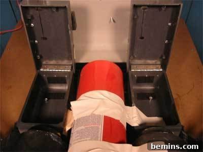 A fire extinguisher sandwiched in between two metal canisters.