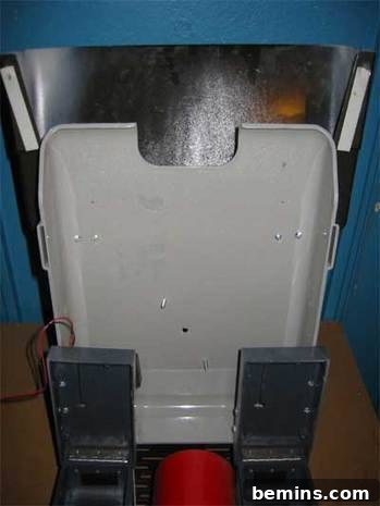Grey plastic rectangle adorned with black rectangles.