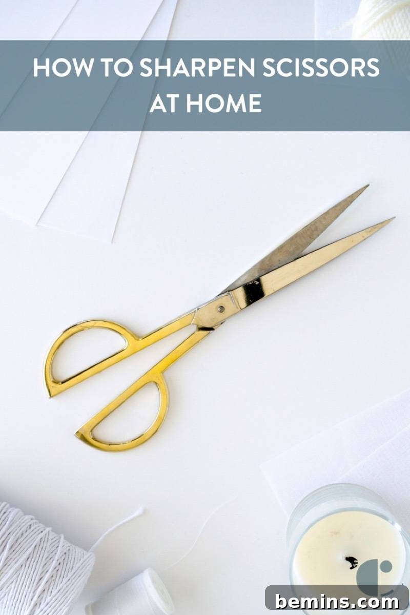 Yellow handled scissors on a white surface, ready to be sharpened.