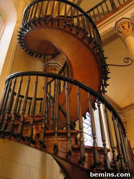 A black and orange round staircase in a house, showcasing a bold and modern design.