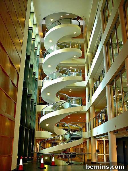 A grand and elegant spiral staircase, showcasing its elaborate design and luxurious materials.