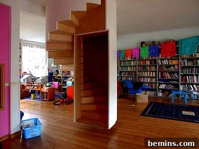 A staircase cleverly integrated with bookshelves, providing both functionality and visual appeal for book lovers.