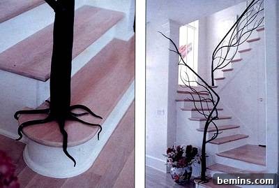 A pink staircase with a tree-shaped railing, showcasing a creative and colorful design.