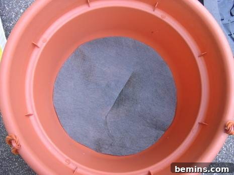 Making an Upside Down Tomato Planter: Cover the bottom of the pot with fabric