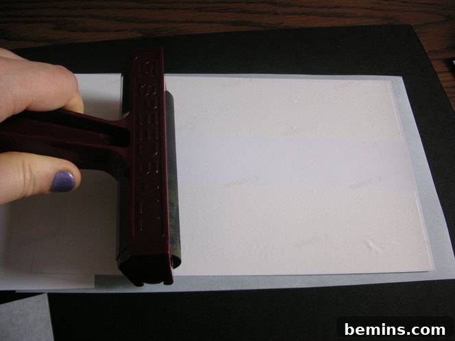 Using a brayer to evenly distribute the adhesive