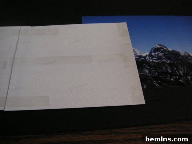 Adding double-sided tape to the corners of the photos