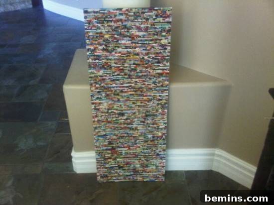A Tall Rectangular Wall Art Piece Made from Rolled Magazine Pages