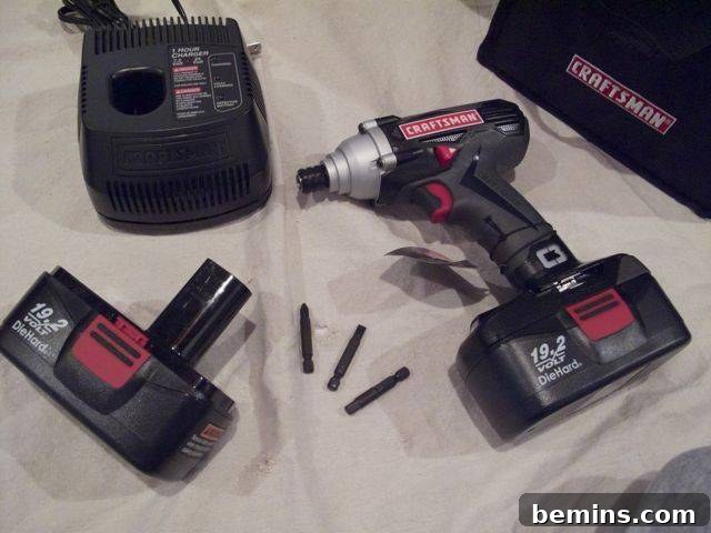 The Craftsman 19.2 C3 Cordless Impact Driver, equipped with a charged battery, resting on a scale to measure its weight and highlight its balanced design.