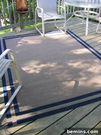 The finished painted rug placed in an outdoor setting with white furniture, showcasing its stylish appearance.