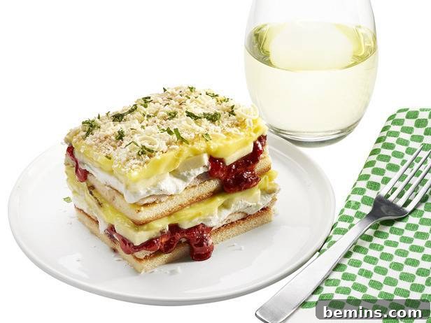 Bread sandwich on plate with water glass and fork on table mat.