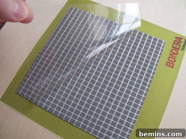 Test Lab Bondera TileMat Set Examination 6 Peeling off the liner from Bondera TileMatSet, revealing the adhesive underneath.