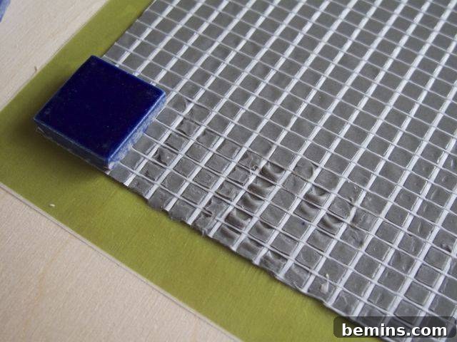 Test Lab Bondera TileMat Set Examination 7 Image showing where a mosaic tile was peeled off from Bondera TileMatSet, revealing the adhesive residue.